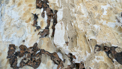 Texture of natural stone. Modern background. Image. Design for poster. Abstract backdrop. Black, grey, biege, sepia. Hole on the surface. Patterns and textures of rocks in nature. Closeup detail stone