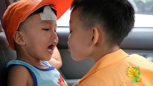 Little boys making fun with kissing together