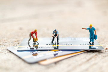 Miniature people : Worker are working on Credit card, Business and Finance concepts