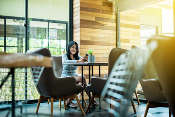 Beautiful asian women using internet with her smartphone in hotel,Happy and smiling,Positive thinking,Copy space for text