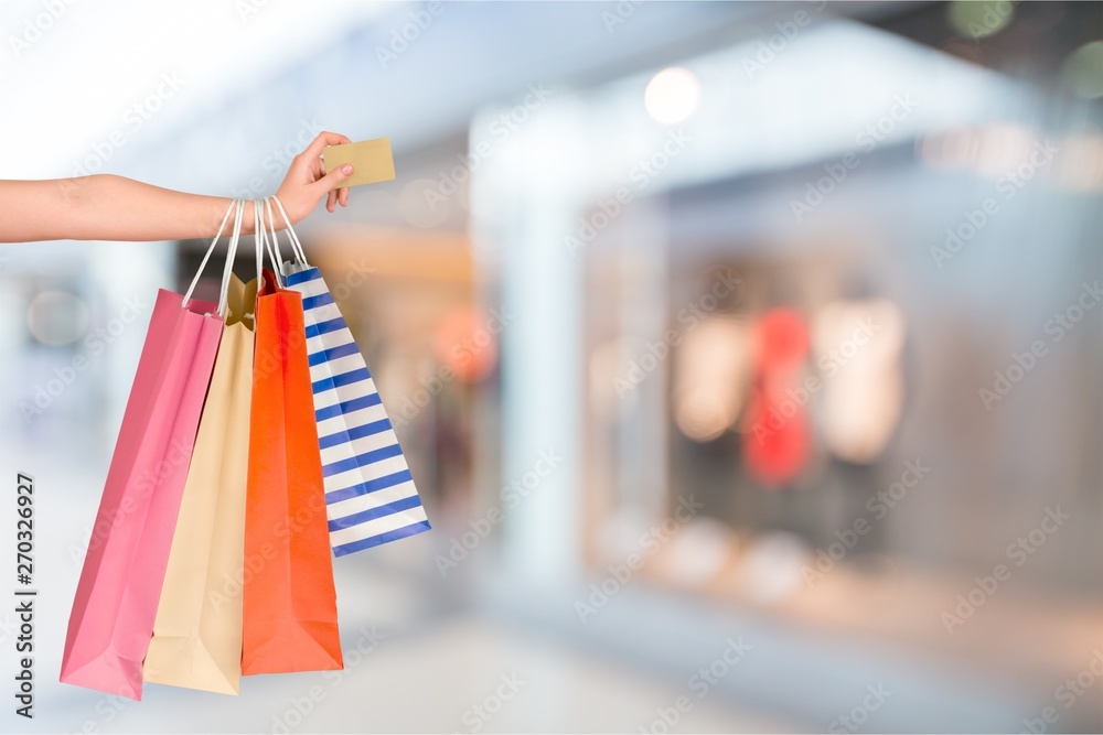 Poster Close up woman hand with many shopping bags and credit card