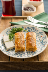 Turkish delicious warm breakfast cheese with borek served with olives and tomatoes and tea