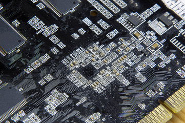 small smd components on a black computer board 