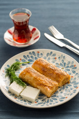Turkish fast breakfast with borek and tomato,cucumber, and pepper