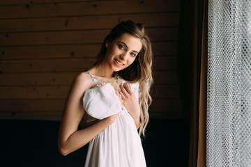 young attractive bride trying on a wedding dress.