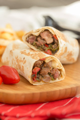 gourmet sliced tortilla roll, burittos, meat wraps with French fries