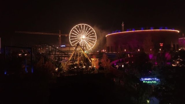 Aerial rising shot of Linnanm&auml;ki Finland Six flags in the evening by night during light carneval