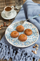 Sekerpare, traditional Turkish Ramadan dessert, top view, wooden table and with Turkish coffee