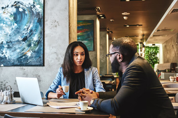 A satisfied customer is the best business strategy of all. Two colleagues having lunch in company's restaurant.