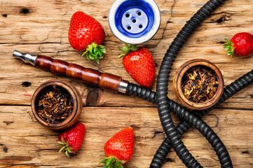 Smoking shisha on strawberry