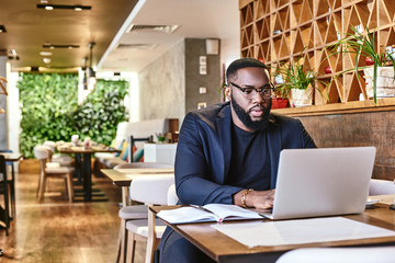 I learned the value of hard work by working hard. African american businessman is working, using...