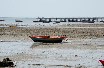 Fishing boat stop and park at the dry sea beach