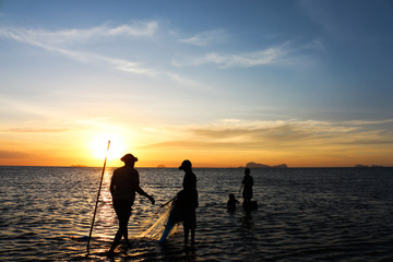 silhouette of fisherman family.
