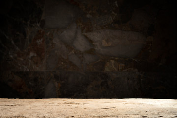 Old wooden table with brick background dark