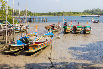 Fototapeta na wymiar Boats tied up in the mud at Saladan, Koh Lanta, Krabi, Thailand