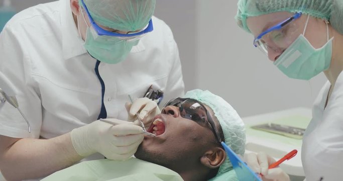 black patient on dental examination by doctor