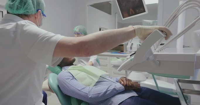 doctor starts dental checkup of black client
