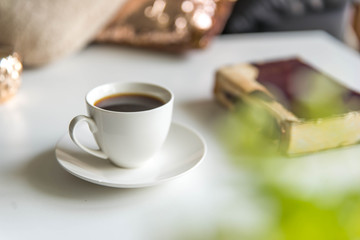 Cup of coffee with an old book. Close up. Break time