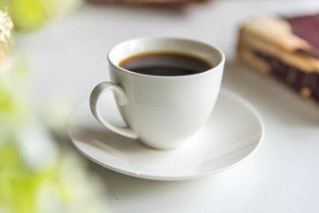 Cup of coffee with a book. close up. Break time