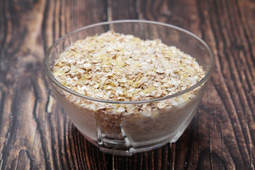 A glass bowl with oatmeal flakes
