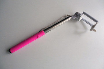  Selfie stick with pink handle and white plastic holder assembled        