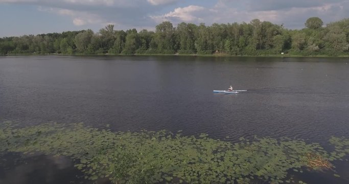 4K. Top view of four athletes in a kayak. Training rowers on the river. Sporting Rowing Team Training. Training of rowers on the river.