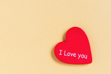 Red heart with text love you on yellow background.