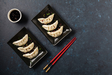 Original Japanese dumplings Gyoza with chicken and vegetables.Top view. Flat lay. Dark blue backgrund.