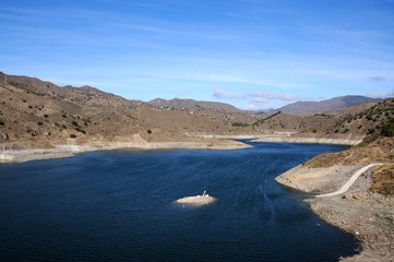 View across La Concepcion reservoir towards the mountains (Embalse del Limonero), Malaga, Spain.