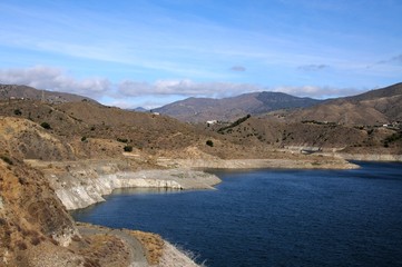 View across La Concepcion reservoir towards the mountains (Embalse del Limonero), Malaga, Spain.