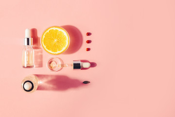 Naklejka premium Serum with vitamin C, concept design. Beauty therapy, body care. Minimalism Flat lay.