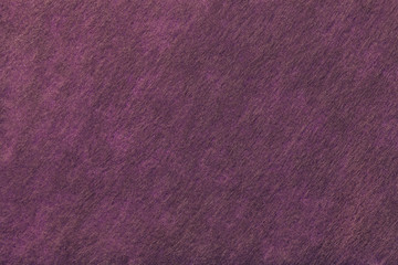 Dark purple and brown background of felt fabric. Texture of woolen textile