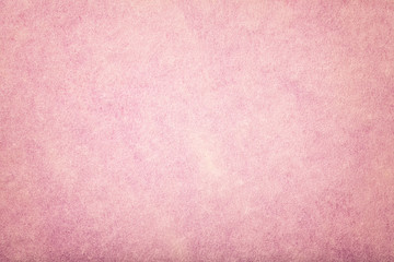 Light pink matt suede fabric closeup. Velvet texture of felt.