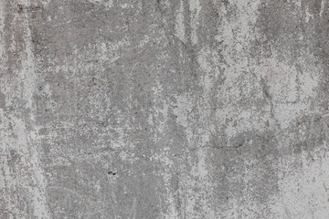 The texture of the old grey concrete wall with scratches, cracks, dust, crevices, roughness, stucco. Can be used as a poster or background for design