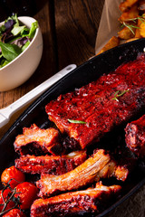 Grilled ribs in spicy marinade with salad and vegetables