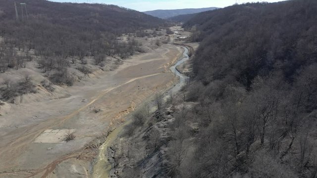 Polluted river stream and coastal area 4K aerial video