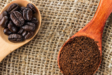 Freshly hot brewed coffee. Coffee beans, cinnamon and anise stars on a dark wooden background