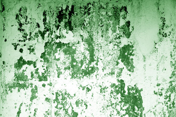 Сraked weathered cement wall texture in green tone.