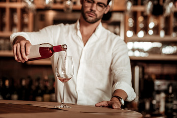 Focused photo on male hand that holding bottle