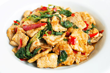 Stir-fried hot and spicy pork with basil on white