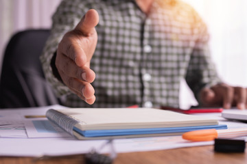 Obraz premium Office desk with businessman handshake holding