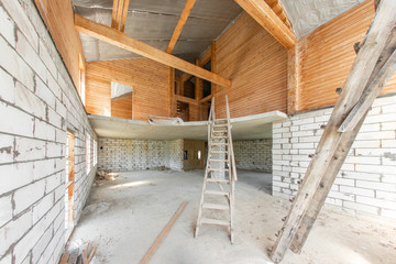 Combined house of wooden beam logs and bricks. The first floor of the house. overhaul and reconstruction. House or apartment is under construction, remodeling, renovation, restoration.