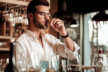 Professional young sommelier working with great pleasure
