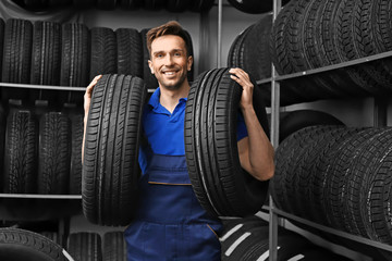 Male seller in car tire store