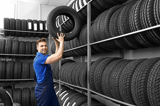Male seller in car tire store