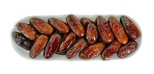 Dried dates over white background. Heap of dried dates isolated on white background.
