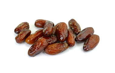 Dried dates over white background. Heap of dried dates isolated on white background.