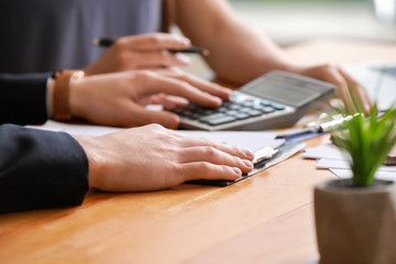 Male and female accountants working in office, closeup
