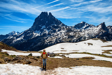 Fototapeta premium hiker woman walking in the french Pyrenees mountains, Pic du midi d Ossau in background