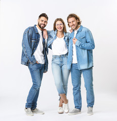 Fototapeta premium Stylish young people in jeans clothes on white background